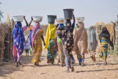 Women carry water back to their homes in a village near Zinder, Niger. The Irish Red Cross supported the construction of the borehole in the village.
