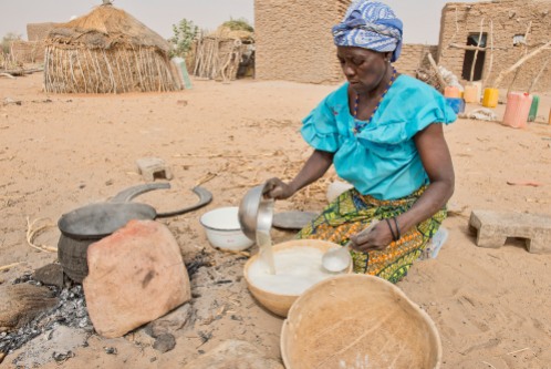 A woman prepares food from millet and water at her home in a village near Zinder, Niger.
